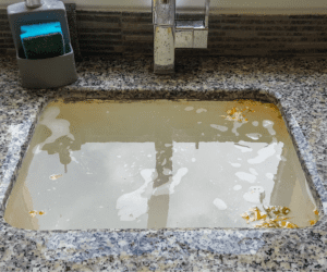 Clogged drain in kitchen sink of Toronto home. 