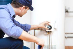 One of our experienced plumbers finishing up a water heater repair in Toronto, ON