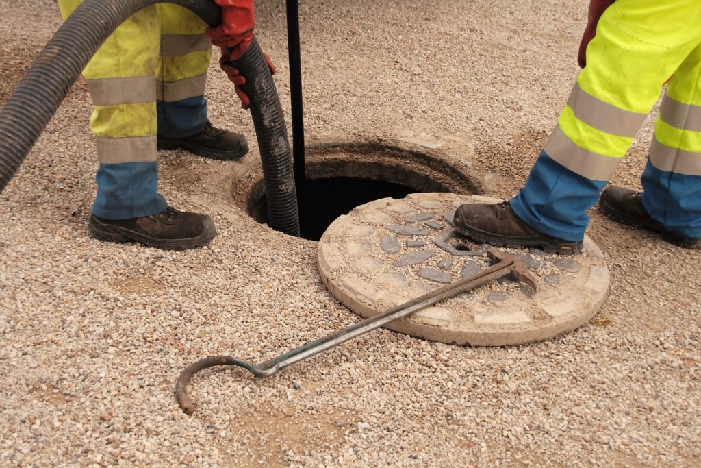 A backwater valve being installed by technicians.