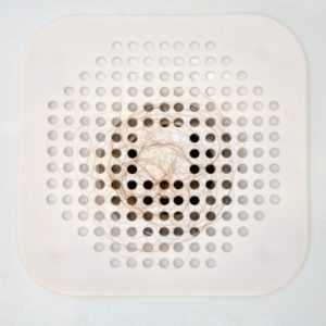 White silicone drain cover with hair