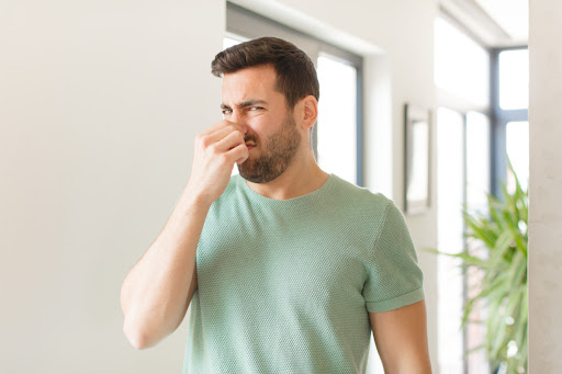 A man holding his nose.