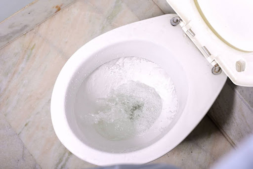 A toilet in the middle of being flushed.